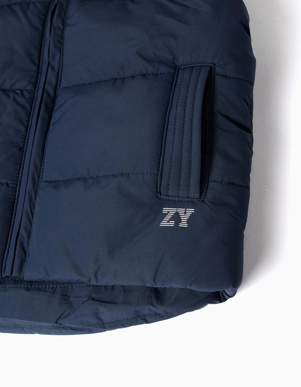 Padded vest with fleece lining and side pockets for babies, navy blue